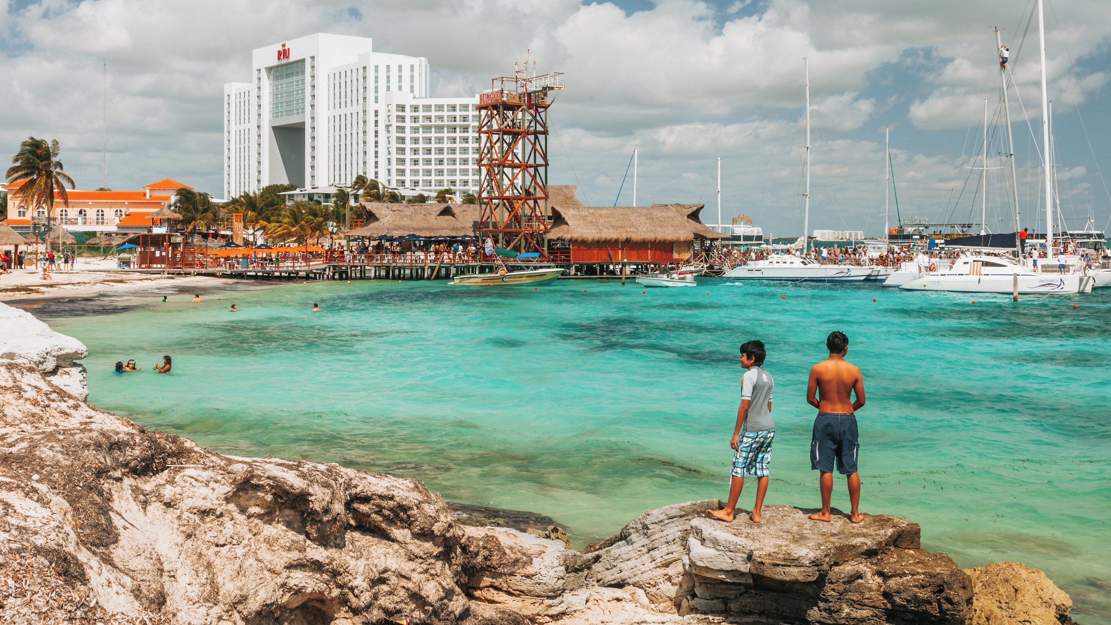 Enjoying leisure time at Playa Tortugas in Cancun, Quintana Roo with clear waters and vibrant atmosphere