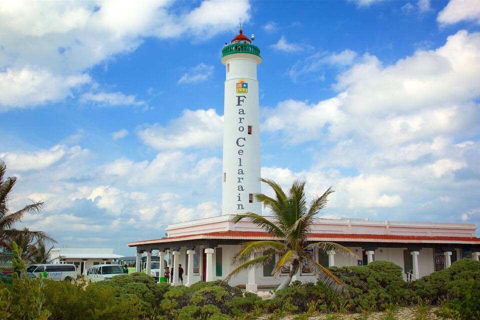 A lighthouse named Farro Celenar with a red roof and white walls, surrounded by lush greenery and palm trees.