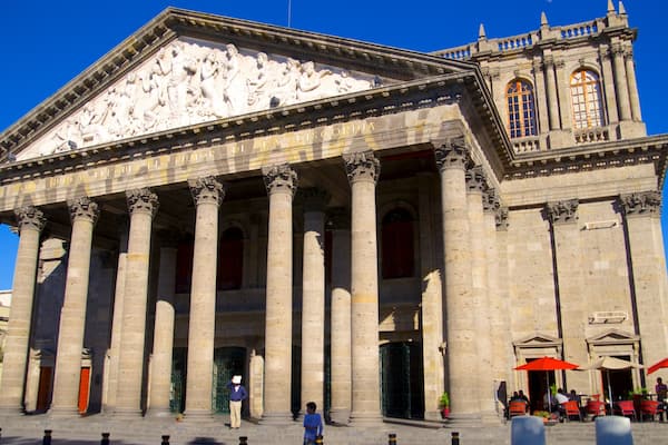 A historic building with classical architecture, featuring columns and detailed sculptures.