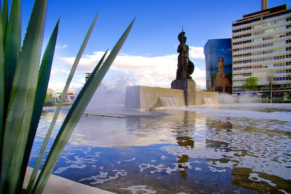 La Minerva featuring a hotel, a statue or sculpture and a pond