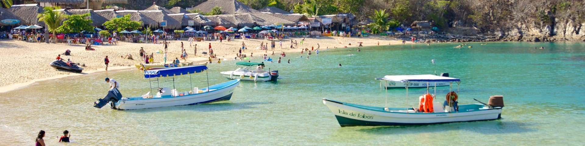 La Entrega Beach which includes a luxury hotel or resort, boating and general coastal views
