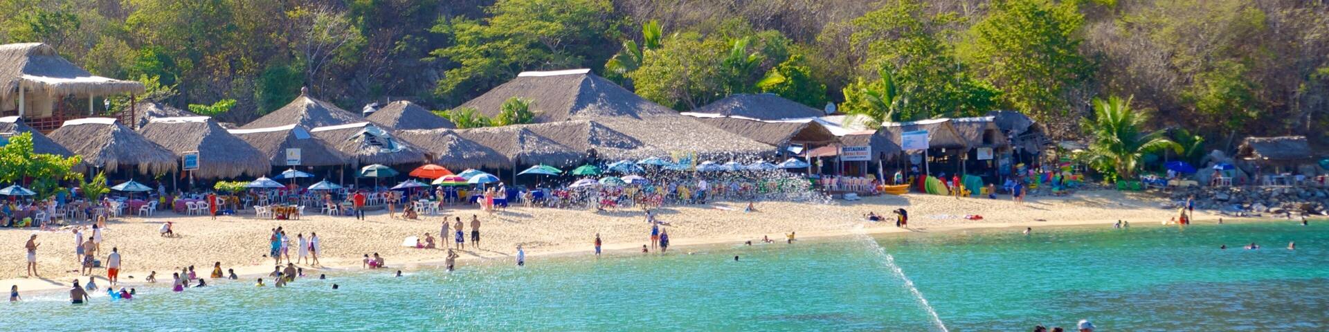 La Entrega Beach which includes a coastal town, a sandy beach and jet skiing