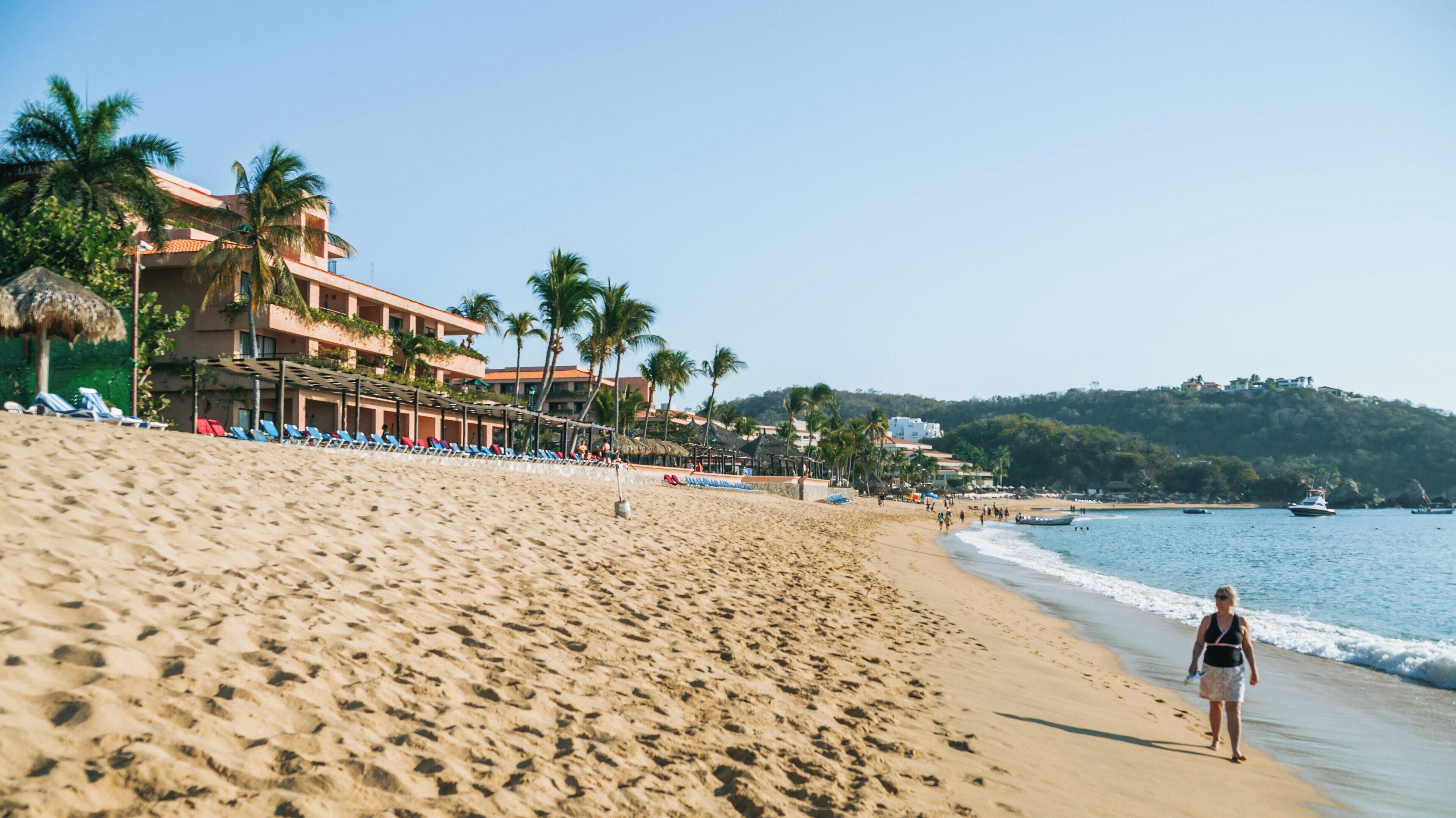 Strolling along the sandy shores of Zaachila Beach in Santa Maria Huatulco, Mexico on a sunny day
