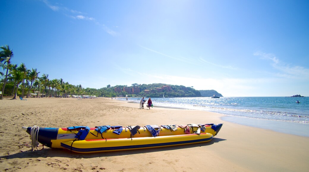 Quieta Beach featuring a sandy beach, landscape views and tropical scenes