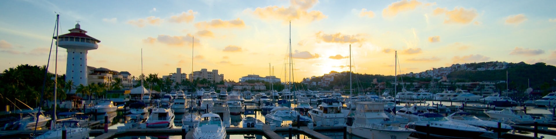 Marina Ixtapa which includes a sunset and a marina