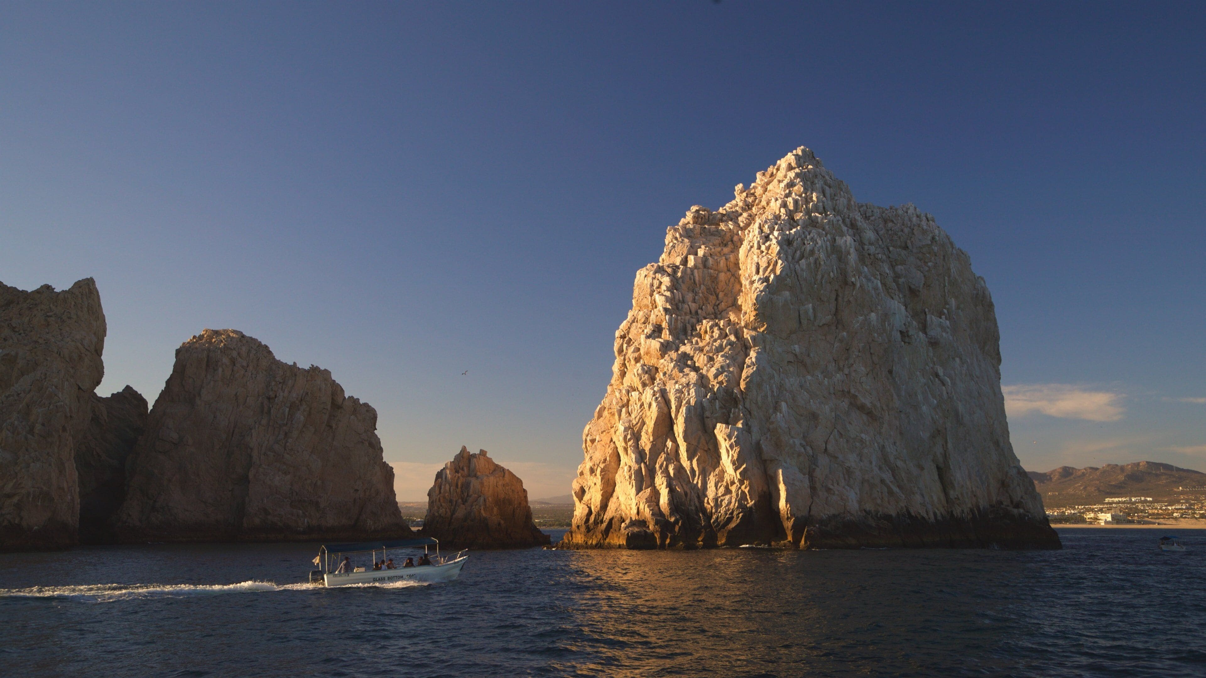 Land\'s End showing rugged coastline, a sunset and boating