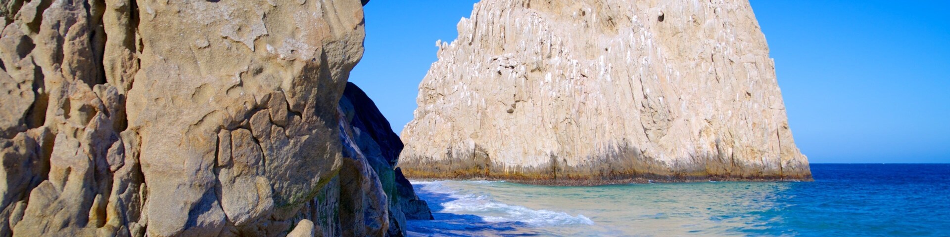 Playa del Amor featuring rugged coastline and a beach