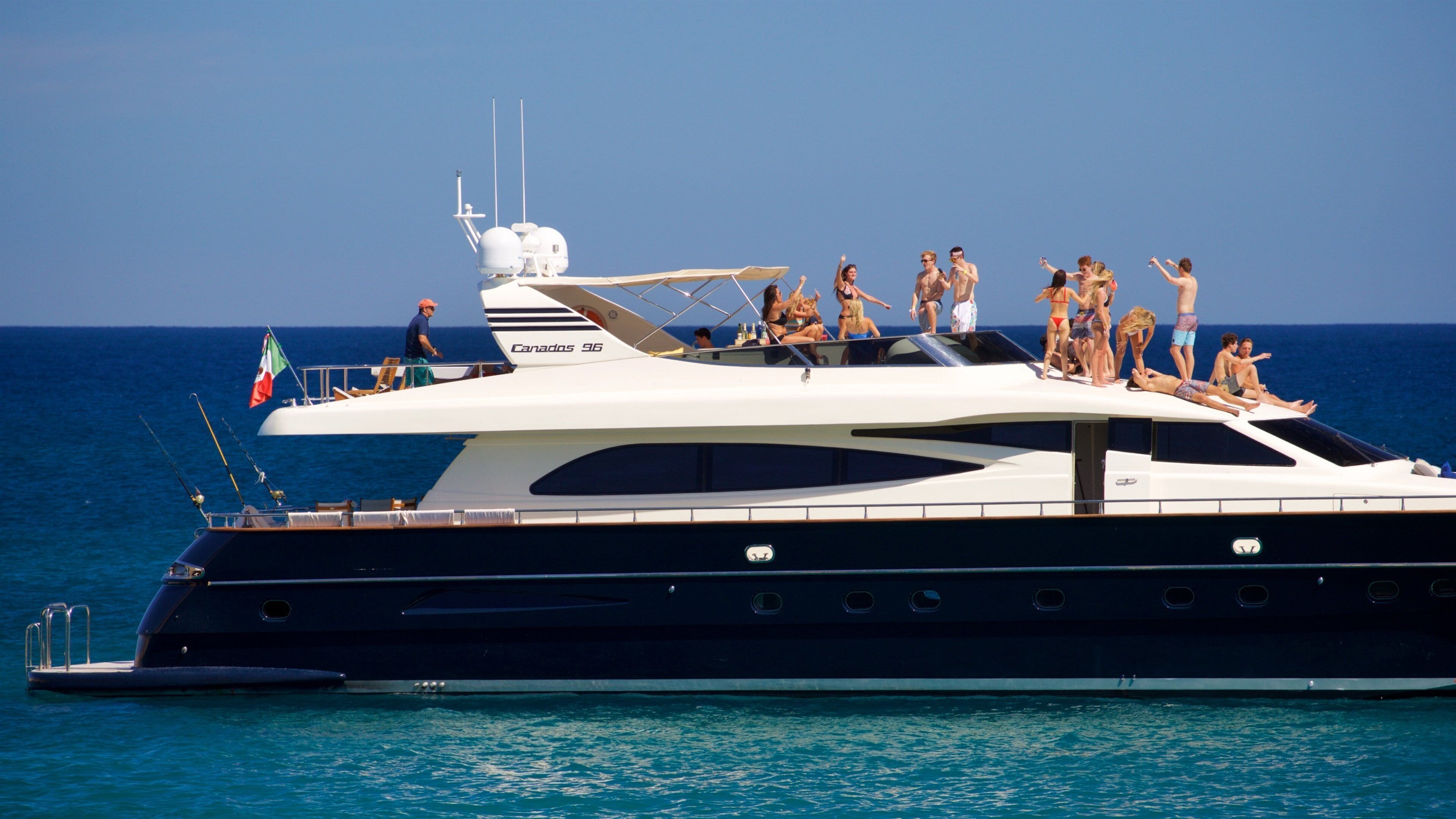 Chileno Beach which includes general coastal views and boating as well as a small group of people