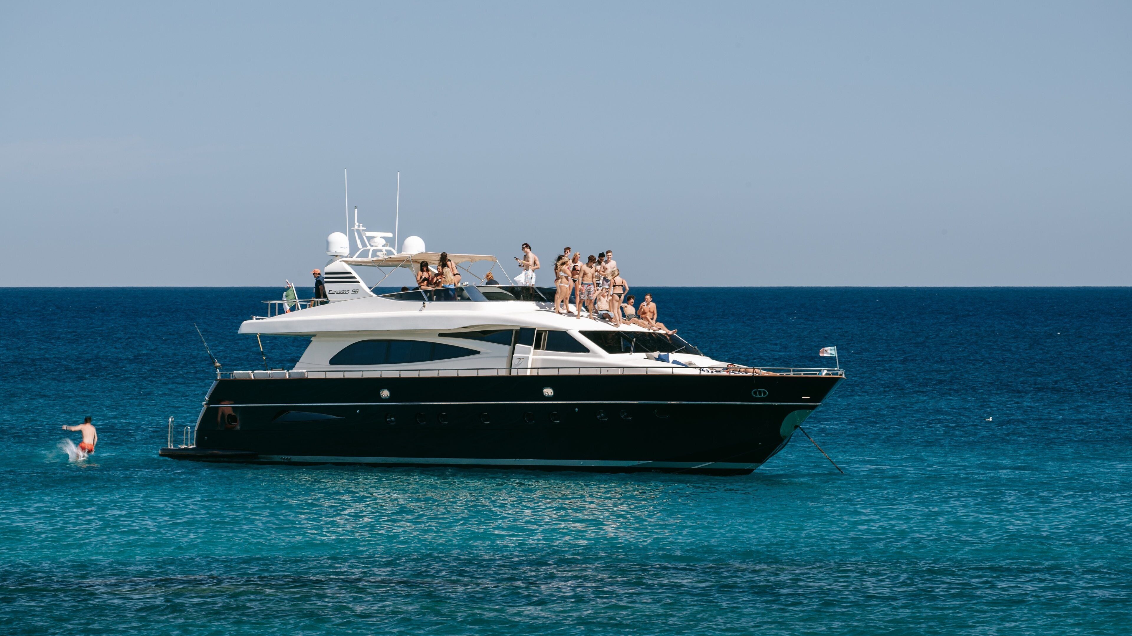 Chileno Beach which includes boating and general coastal views as well as a small group of people