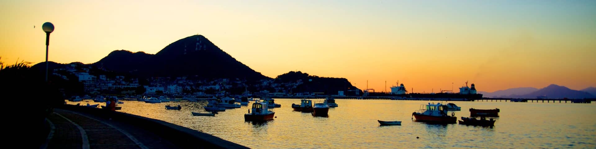 Playa San Pedrito featuring a bay or harbor, a sunset and general coastal views