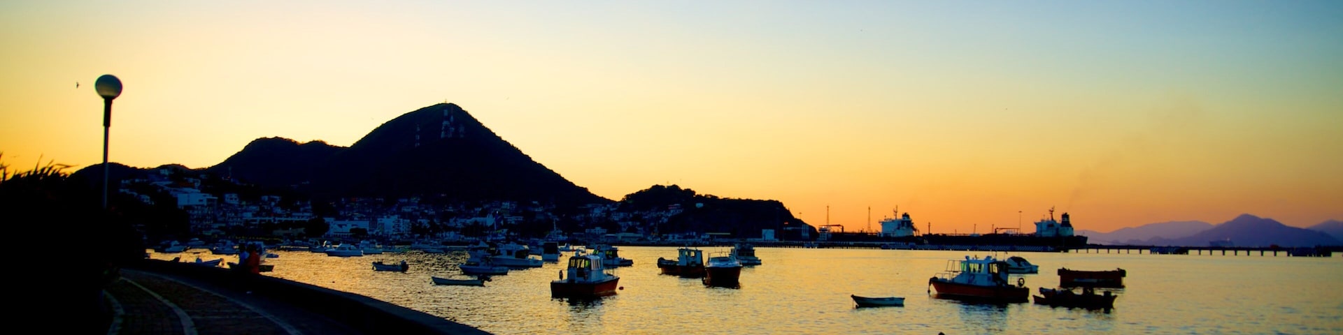 Playa San Pedrito featuring general coastal views, a bay or harbour and a sunset