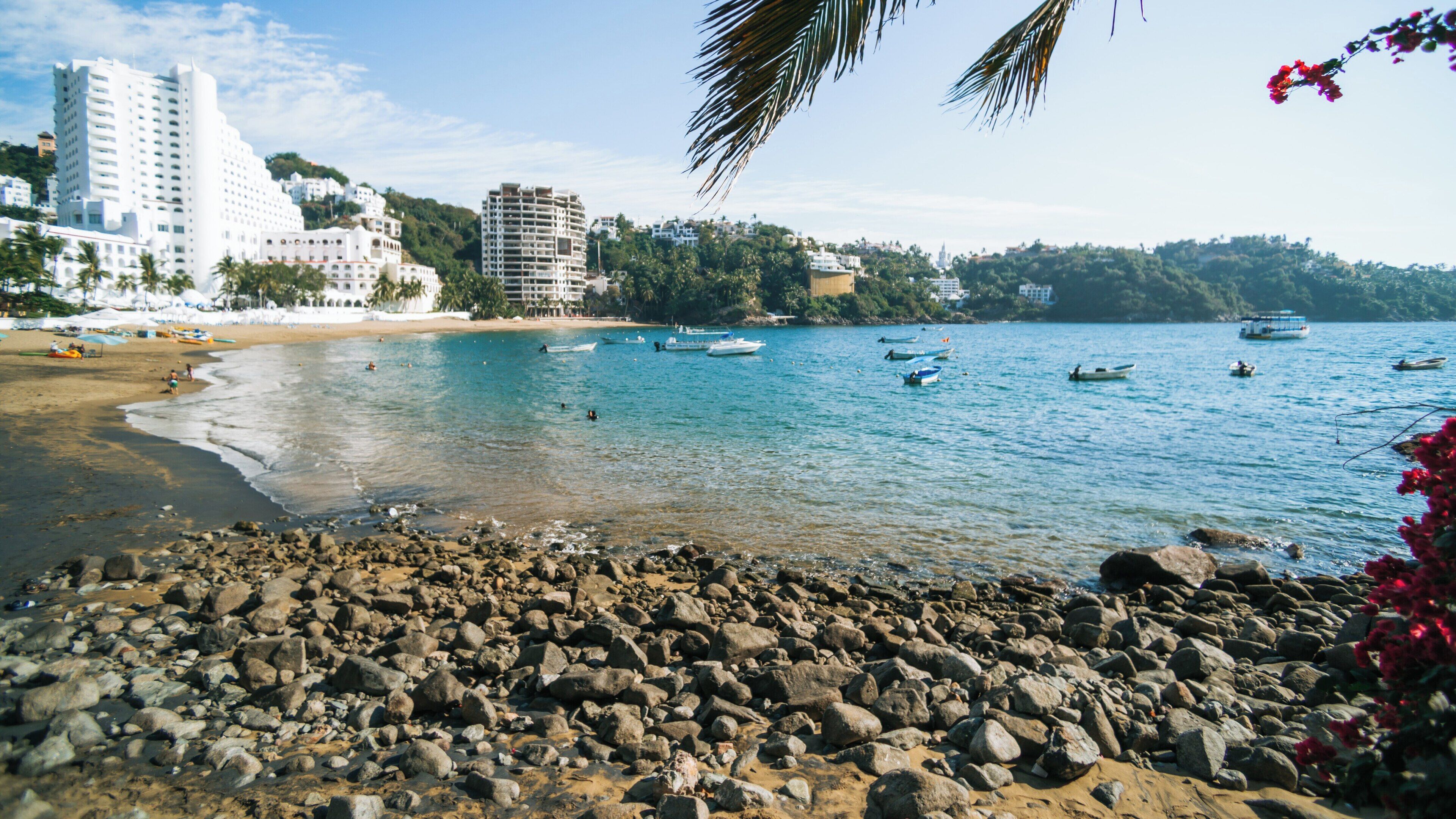 Picturesque Playa La Audiencia in Manzanillo, Colima, Mexico, showcasing golden sands, beautiful waters, and nearby resorts during a sunny day
