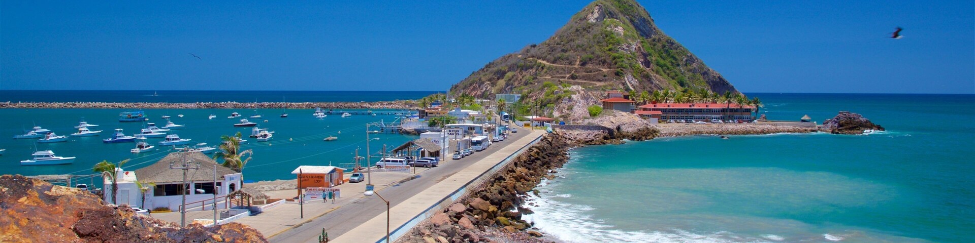 El Faro Lighthouse which includes mountains, general coastal views and rocky coastline