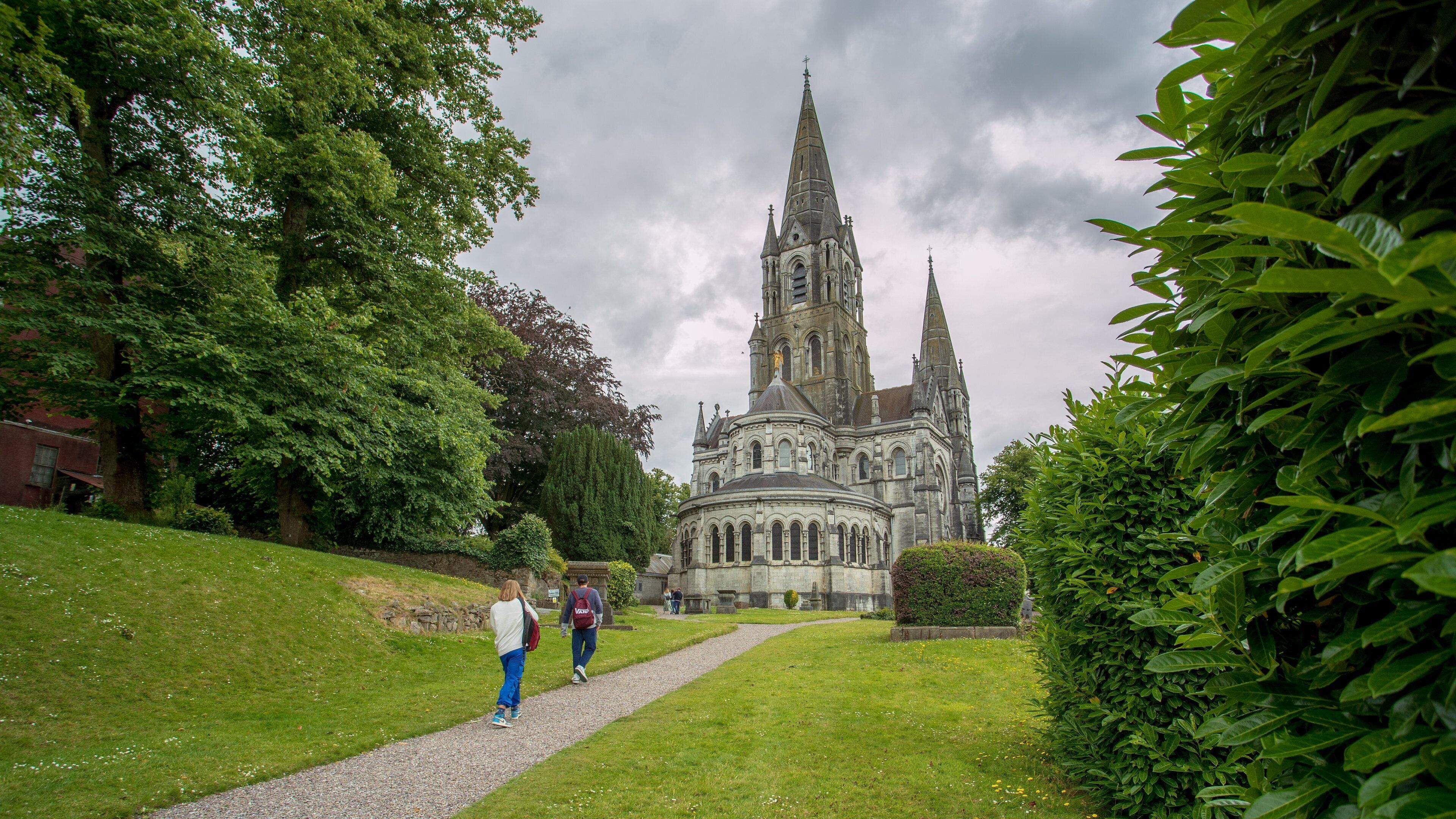 Saint Fin Barre\'s Cathedral showing heritage architecture, a park and chateau or palace