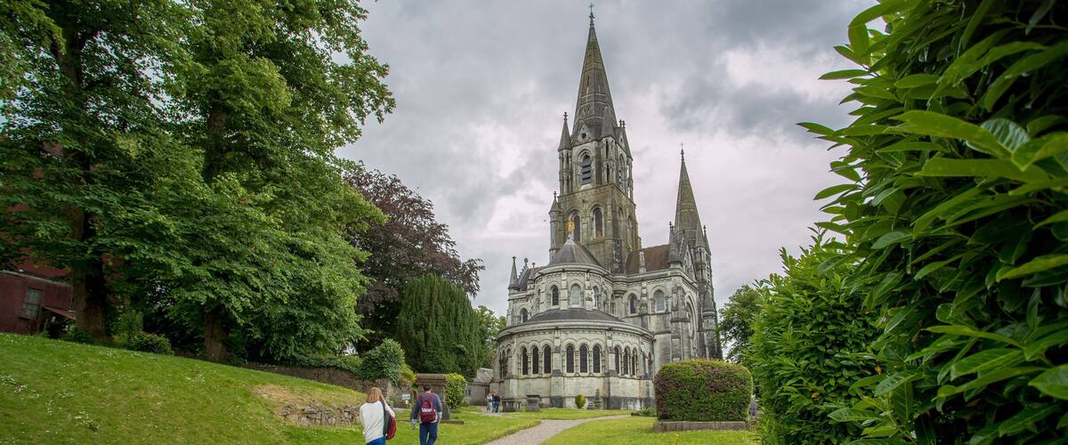 Saint Fin Barre\'s Cathedral showing heritage architecture, a park and chateau or palace