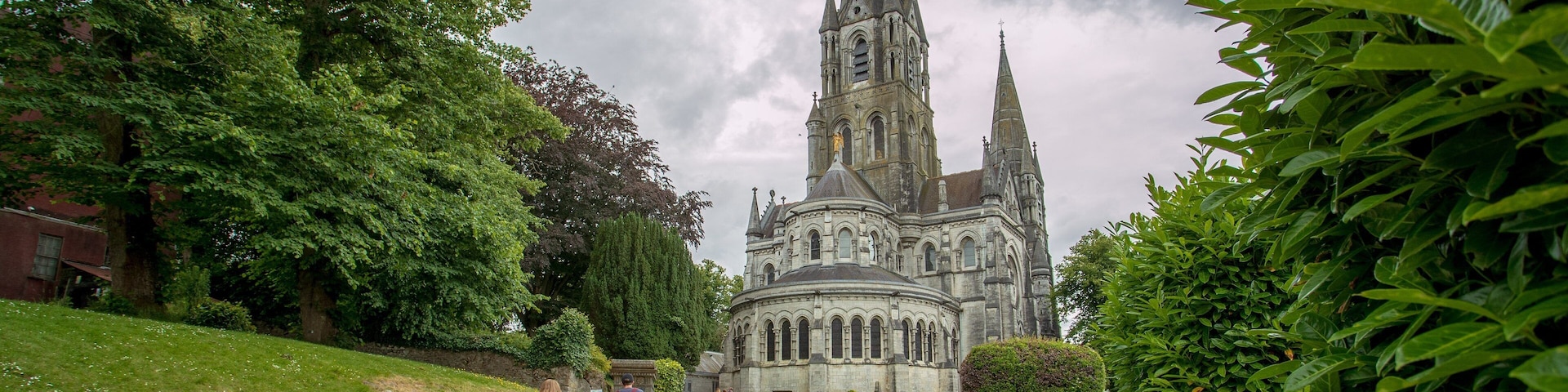 Saint Fin Barre\'s Cathedral showing heritage architecture, a park and chateau or palace