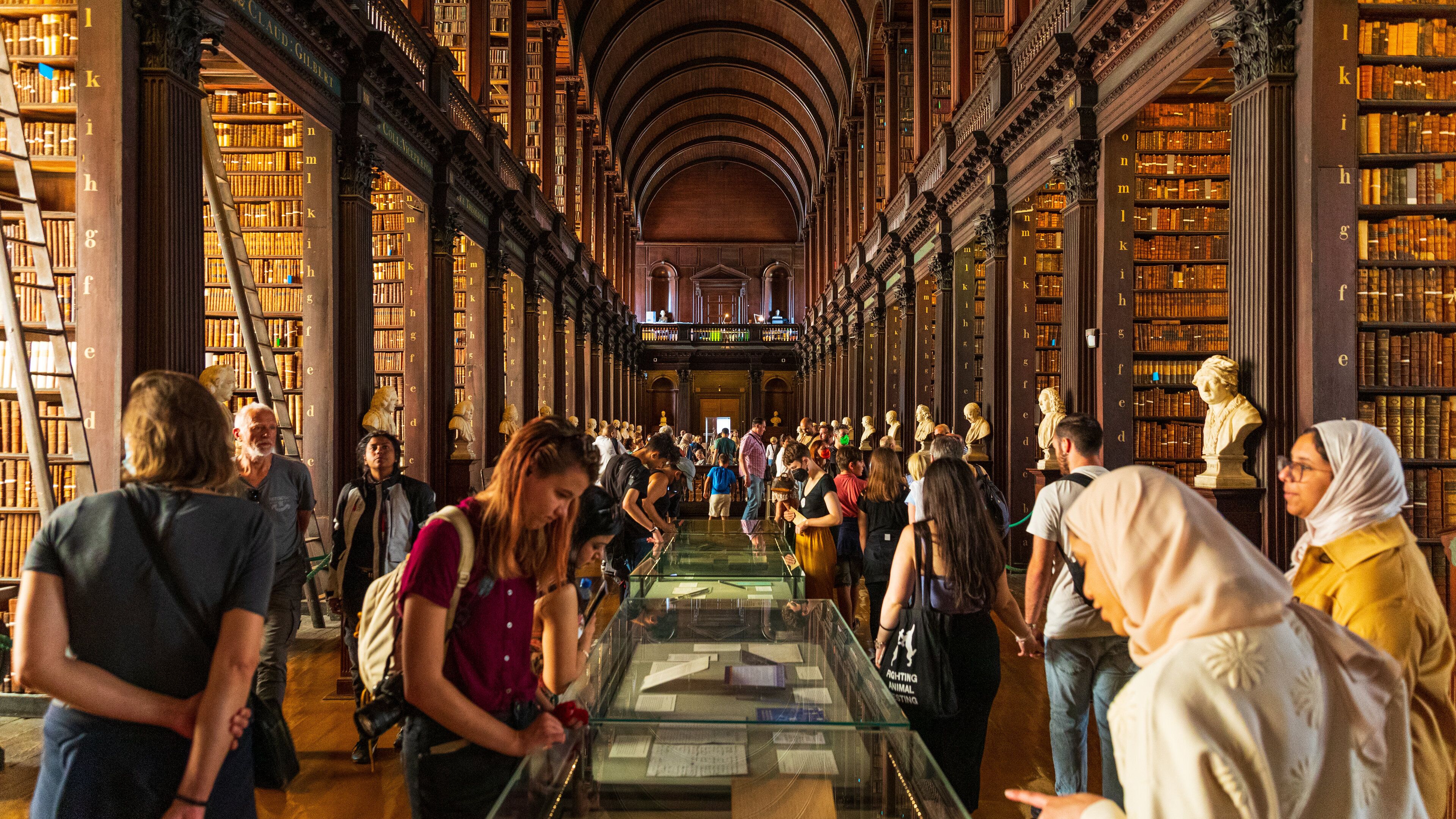 The Book of Kells showing heritage elements and interior views as well as a large group of people