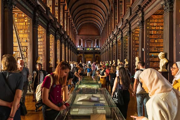 The Book of Kells showing heritage elements and interior views as well as a large group of people