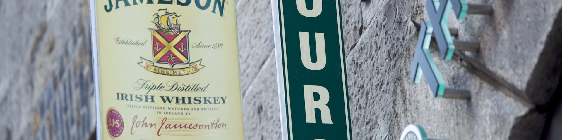 Historic distillery sign indicates tours at Jameson Distillery Bow St. in Dublin, Ireland