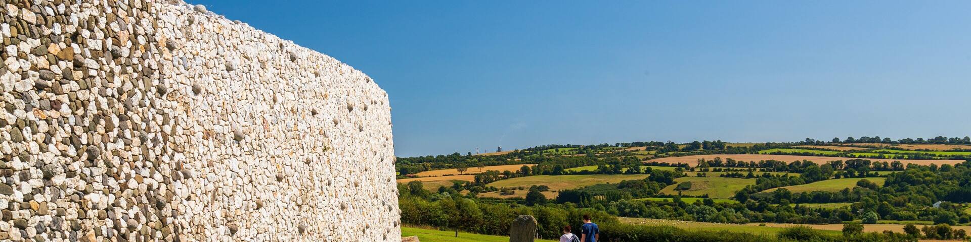 Newgrange showing heritage elements and tranquil scenes as well as a couple