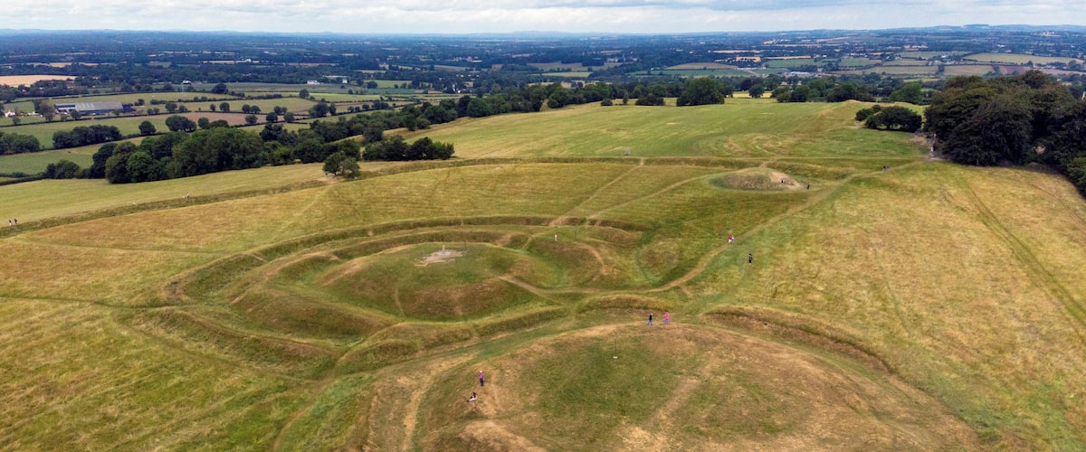 An aerial view of the Hill of Tara located in the Boyne Valley in Ireland. The Hill of Tara was the ancient inauguration site of the High Kings of Ireland. The small mound in the top right of the photo is a passage tomb known as Dumha na nGiall “Mount of Hostages” and dates from the Neolithic Age around 3,000 BC. #History