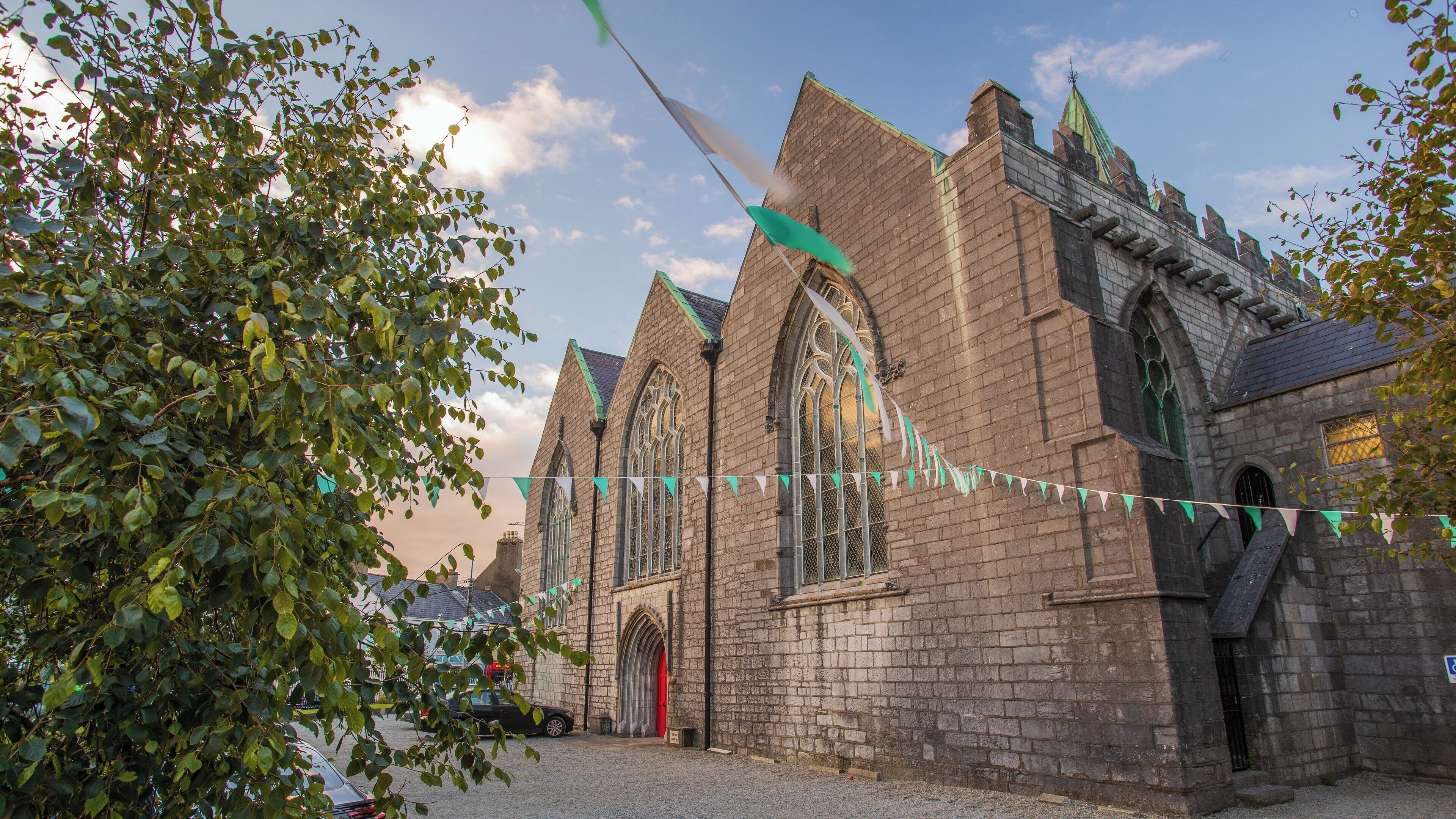 St. Nicholas' Collegiate Church stands proudly in Galway City Centre, showcasing its historic architecture amid festive decorations and a lively atmosphere