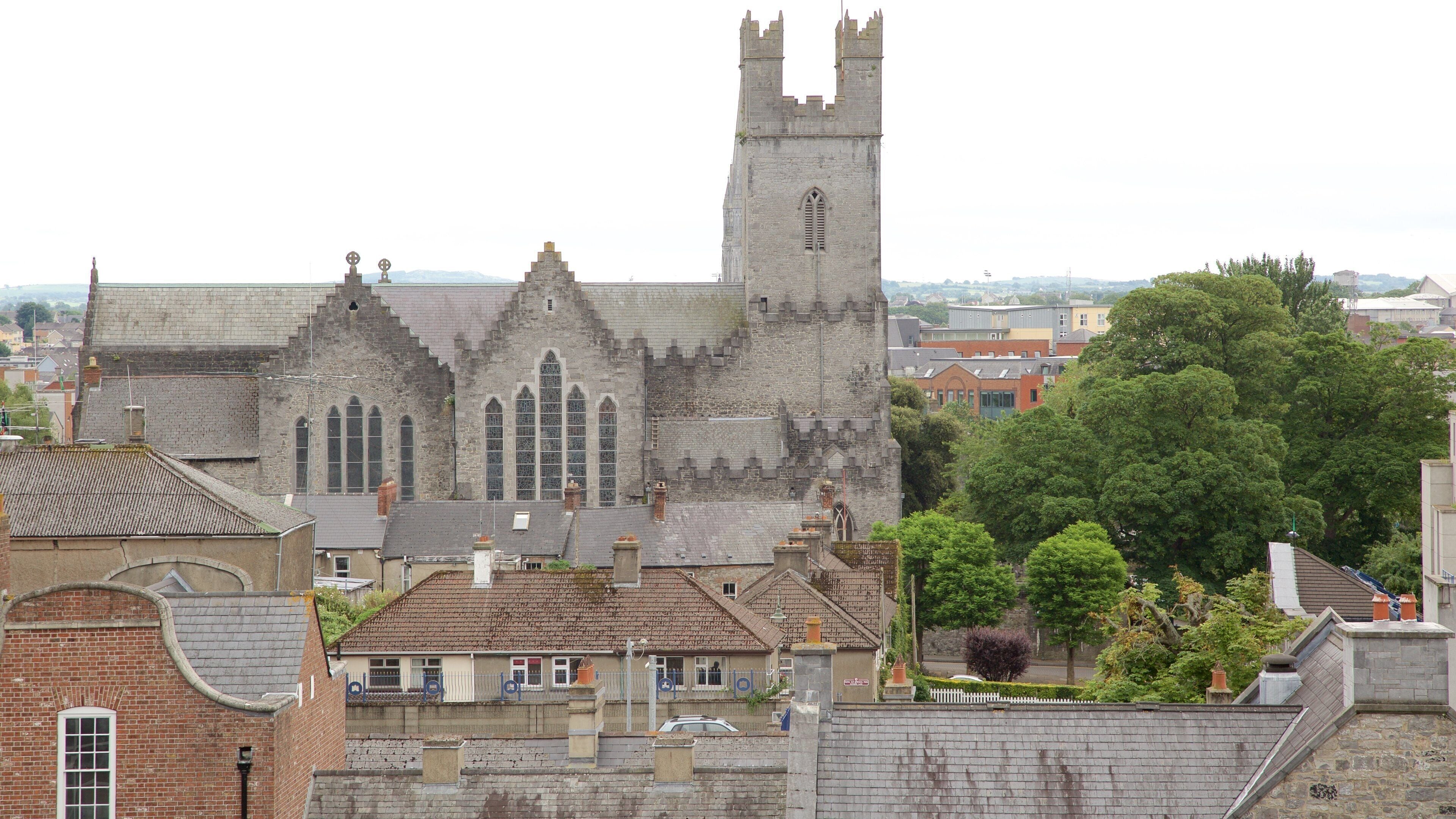 A historic church with a tall tower and arched windows.