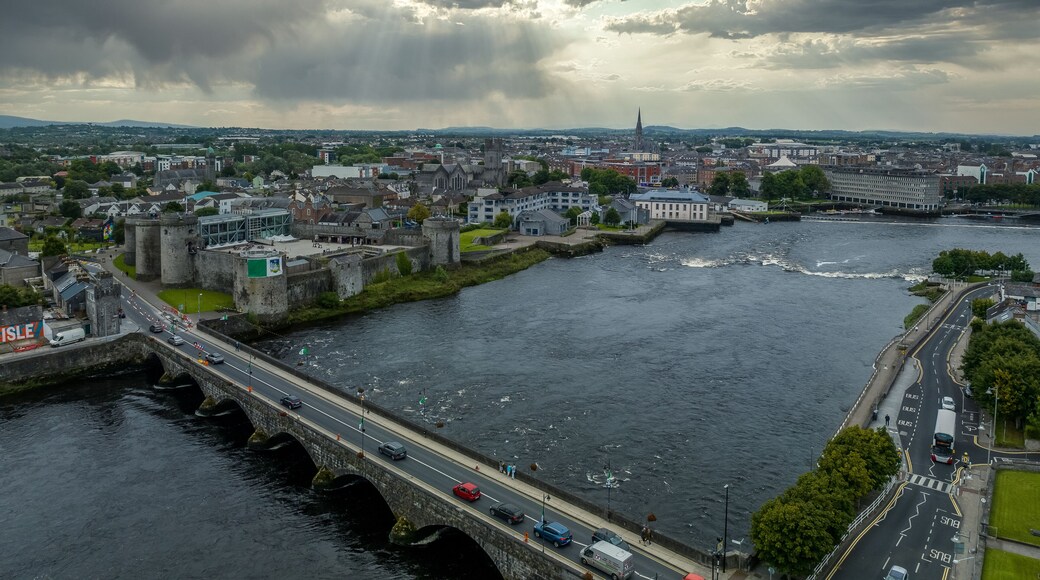 King John castle in Limerick Ireland on the banks of the Shannon river next to the Thomond bridge with dramatic cloudy sky