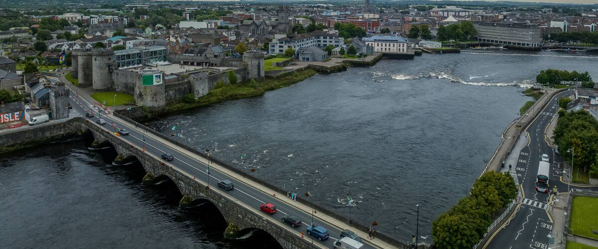 King John castle in Limerick Ireland on the banks of the Shannon river next to the Thomond bridge with dramatic cloudy sky