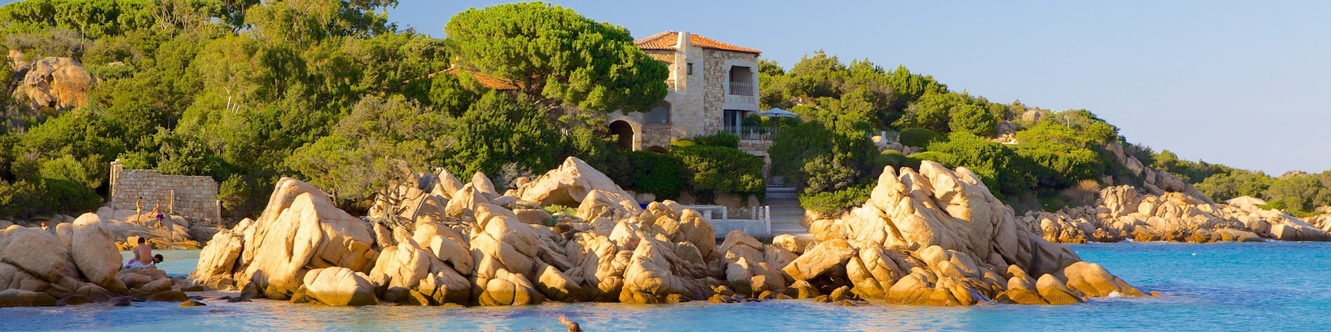 Capriccioli Beach which includes a coastal town, swimming and landscape views