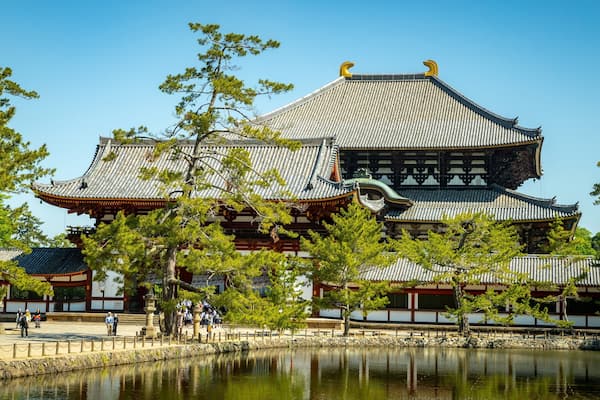 Todaiji Temple which includes a lake or waterhole, a temple or place of worship and heritage elements