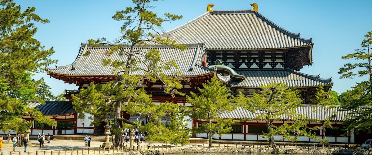 Todaiji Temple which includes a lake or waterhole, a temple or place of worship and heritage elements