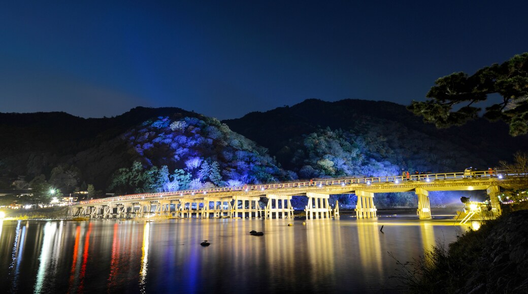 Togetsu Bridge reflecting in the Katsura River at night during the December illumination festival in the Arashiyama area of Kyoto