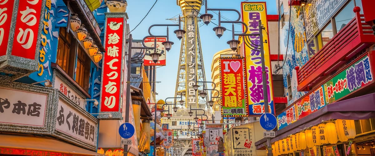 Tsutenkaku Tower showing a city, cbd and signage