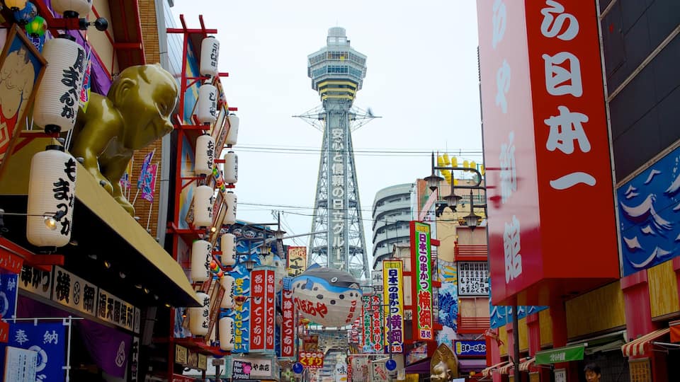 Tsutenkaku Tower featuring street scenes, a skyscraper and a city