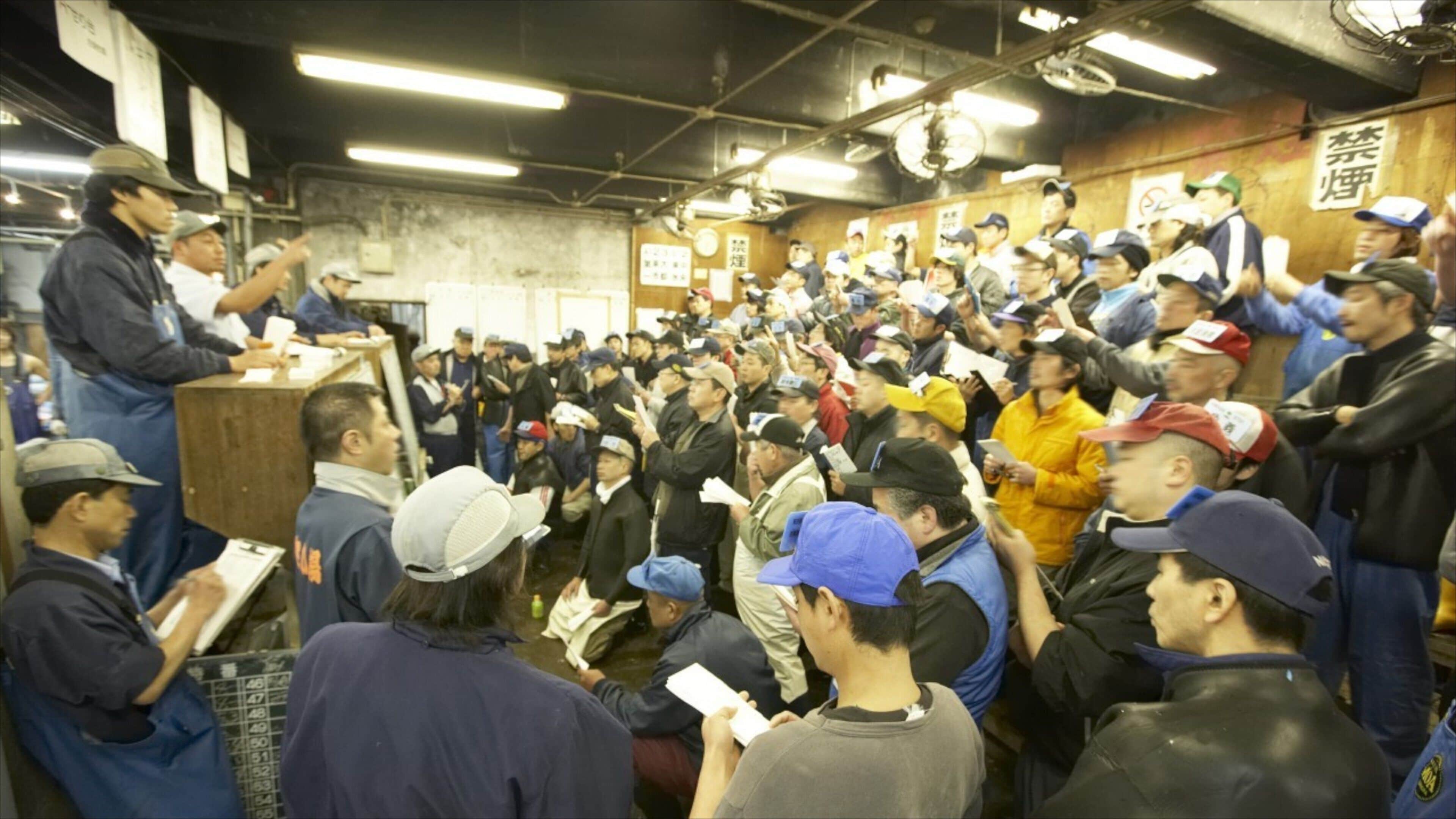 Tsukiji Fish Market which includes interior views and markets as well as a large group of people