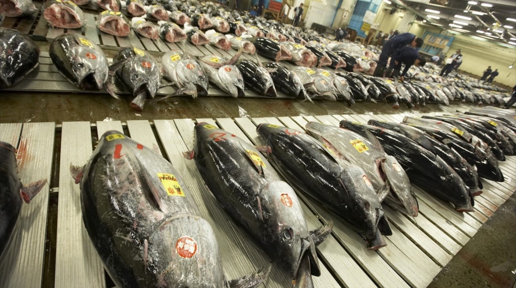 Toyosu Market featuring markets and interior views as well as a large group of people