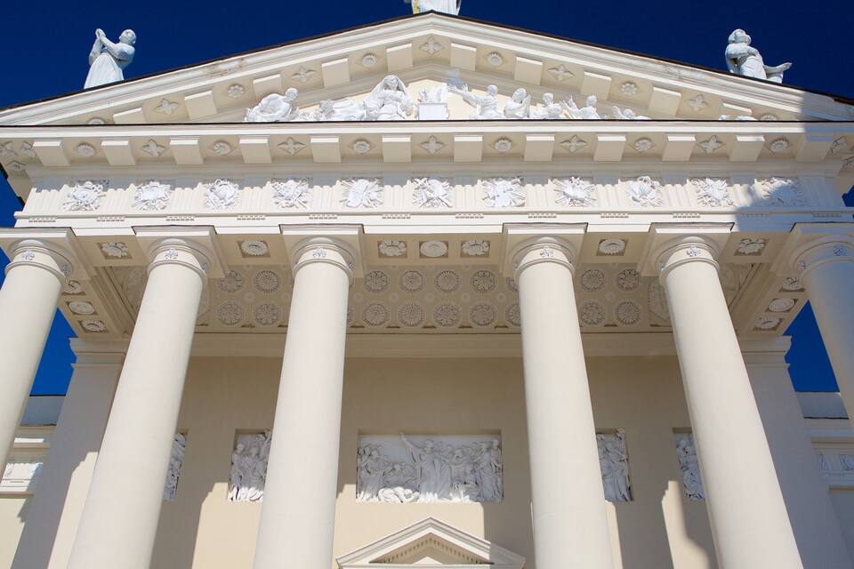 A neoclassical building with columns and detailed sculptures.
