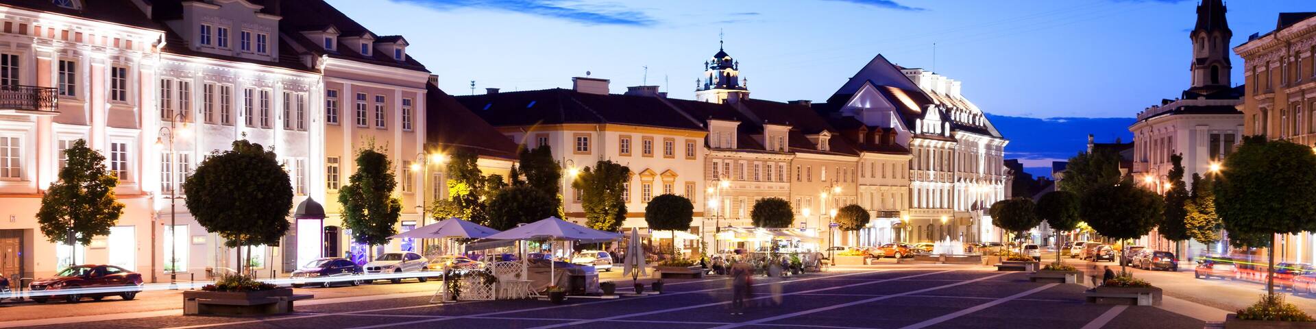 Vilnius, the capital of Lithuania at sunset, a street and square with bright night lights in the historic center of the city at night, a popular destination for travel in Europe