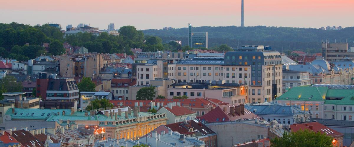 A cityscape with a prominent tower and a mix of historic and modern buildings.
