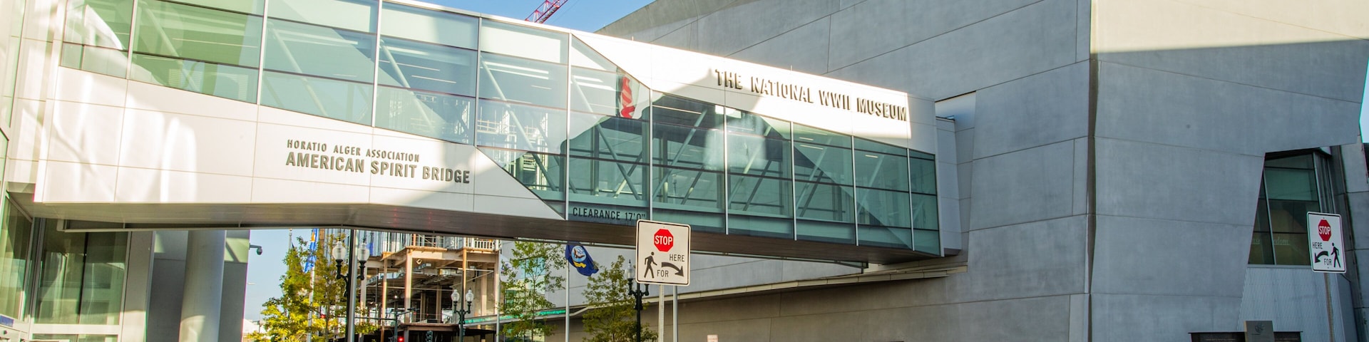 National World War II Museum which includes a city, street scenes and a bridge