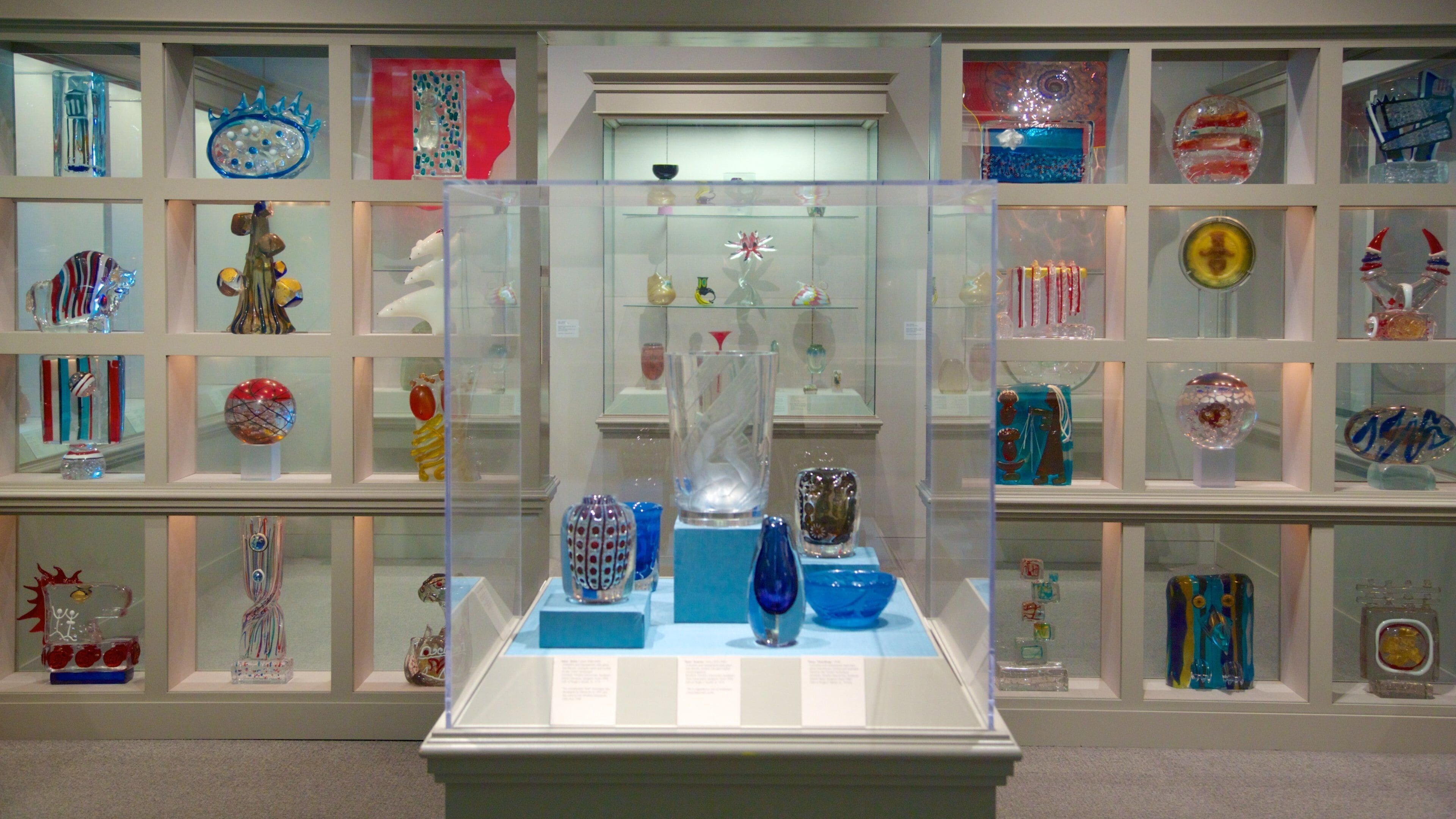 A museum display of colorful glass art.