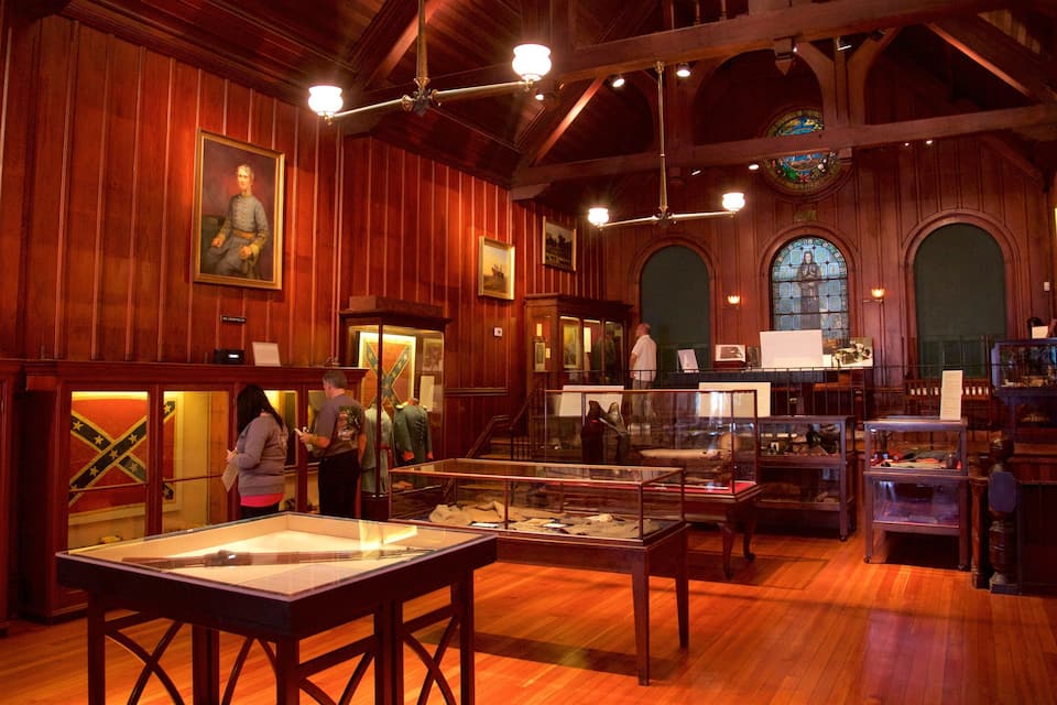 A museum with wooden interiors, glass display cases, and historical artifacts.
