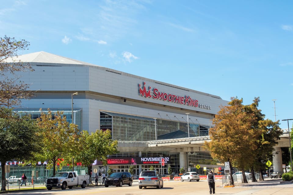 A modern building with a large sign reading "Smoothie King Center" and a banner for "November 02".