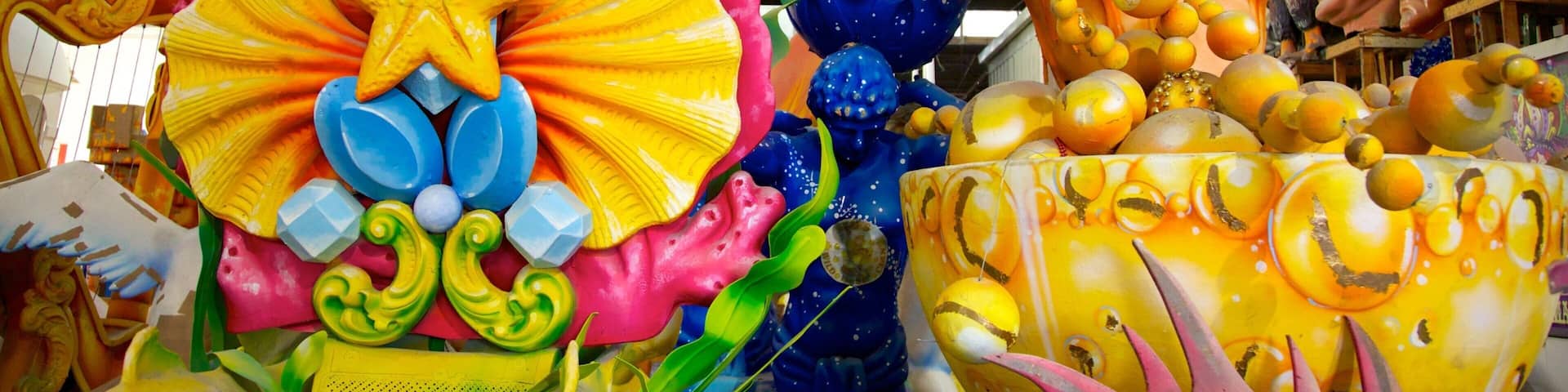 A colorful sculpture with a star, flowers, and a figure holding a ball.