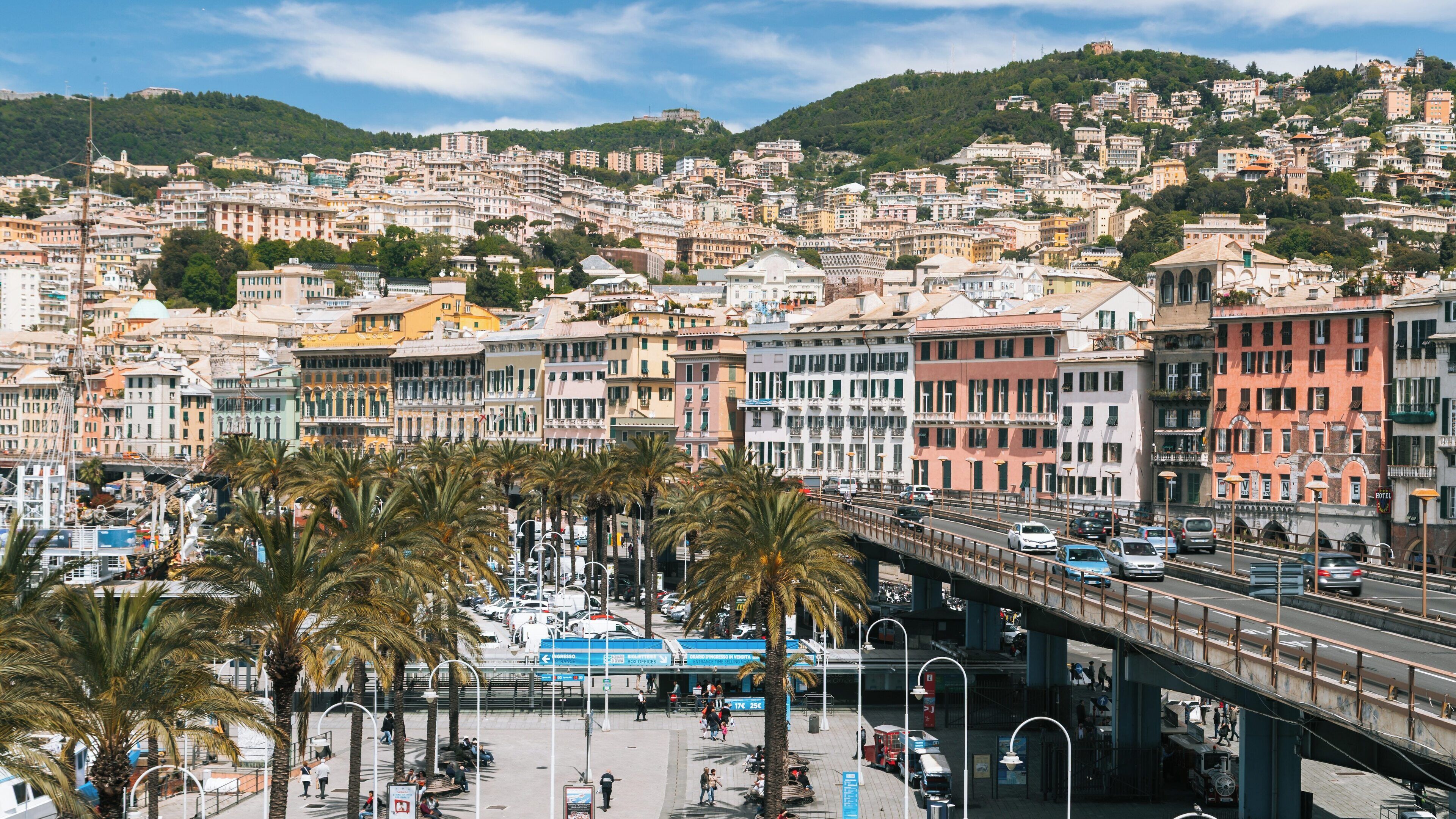 Vibrant waterfront at Old Port in Centro Est, Genoa, Liguria, Italy showcasing palm trees and historic architecture