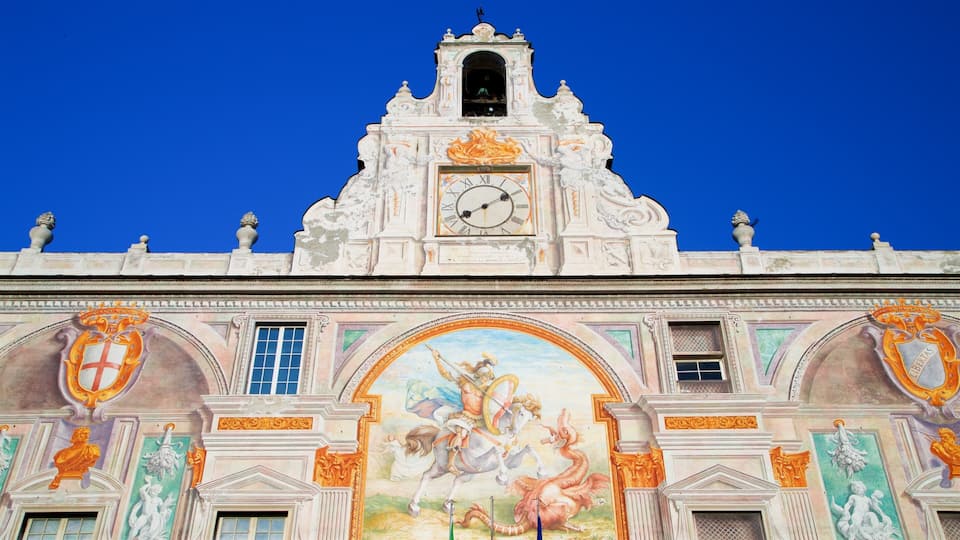 A historic building with ornate architecture, a clock tower, and a mural depicting a mythological scene.