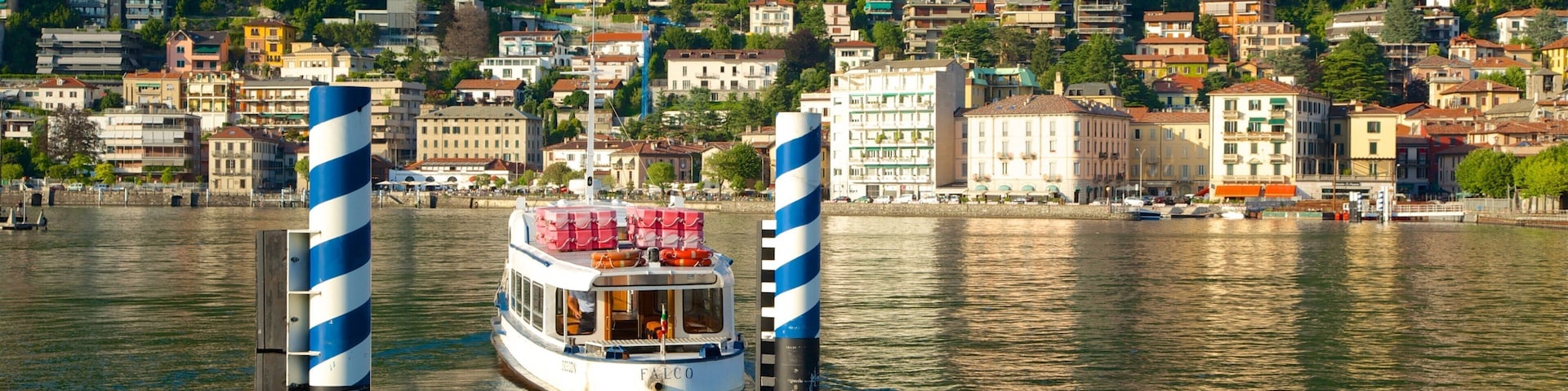 Piazza Cavour featuring a marina, a ferry and a coastal town