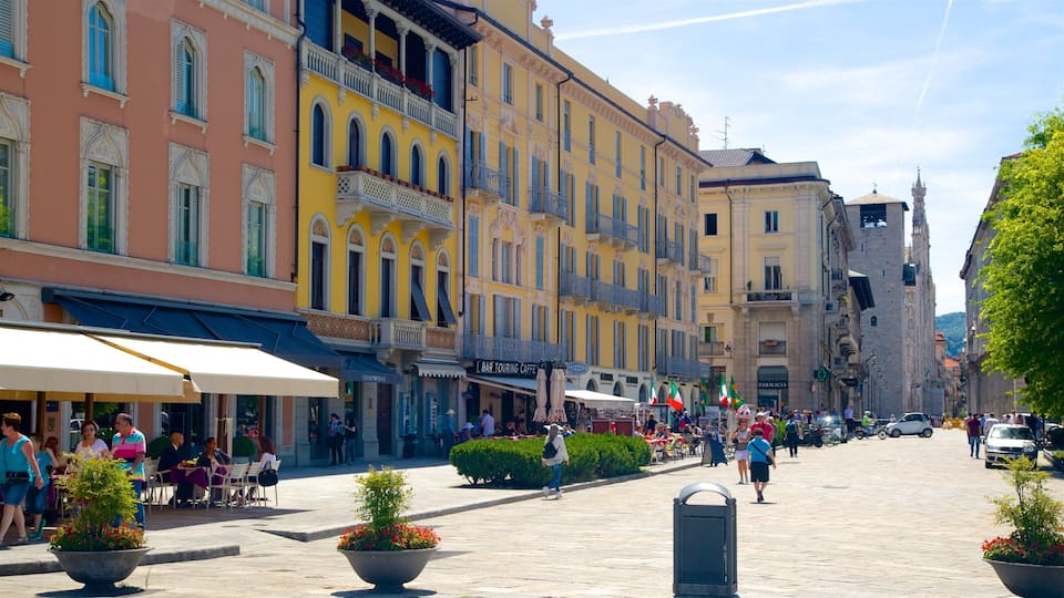 A bustling European street with colorful buildings, outdoor cafes, and pedestrians.