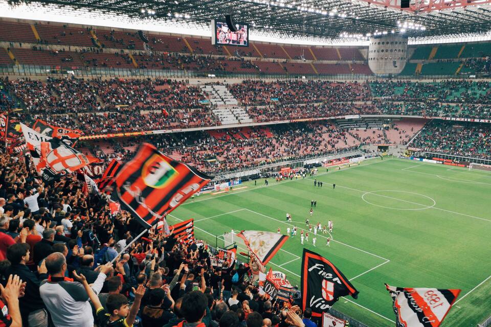 Un estadio lleno de aficionados con banderas y pancartas.